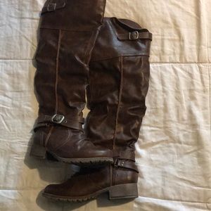 Brown, knee high leather boots.